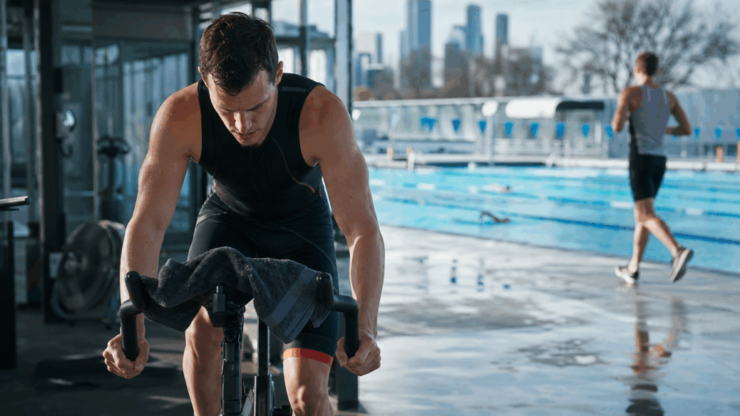 Melbourne triathlete training indoors beside an outdoor pool in winter
