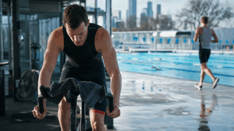Melbourne triathlete training indoors beside an outdoor pool in winter