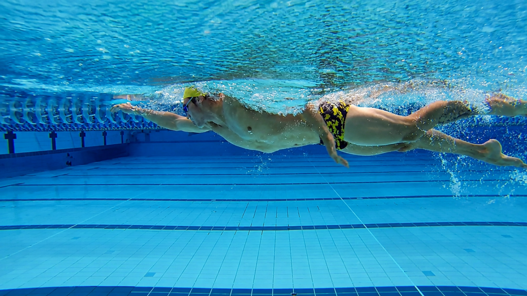 Triathlete practising an efficient freestyle kick in a swimming pool