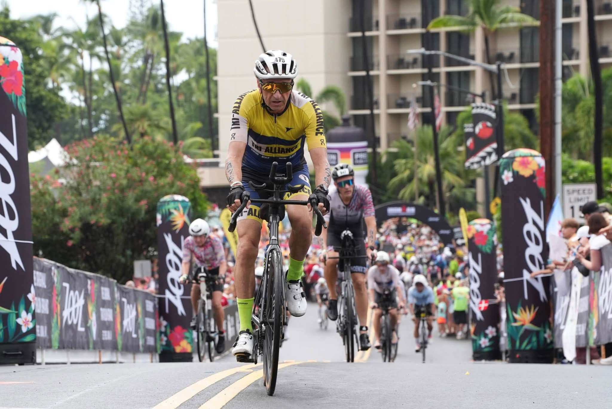 Mario Staffieri in Tri Alliance kit riding a borrowed road bike at Kona